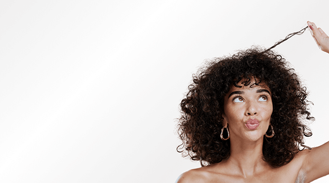 Curly girl looks at her hair